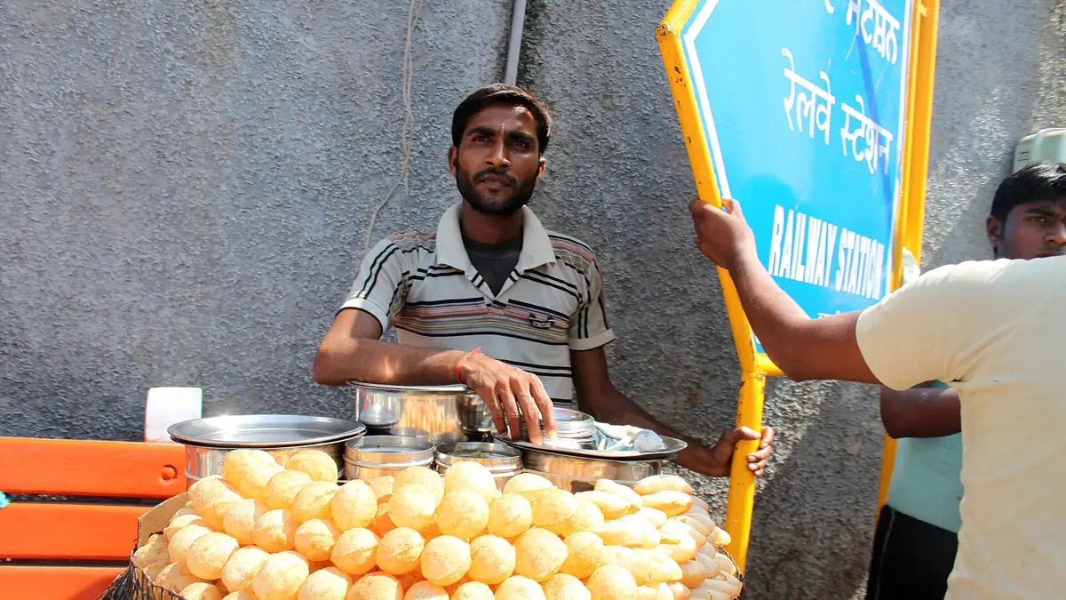 A street food vendor serving from a large basket in Amritsar