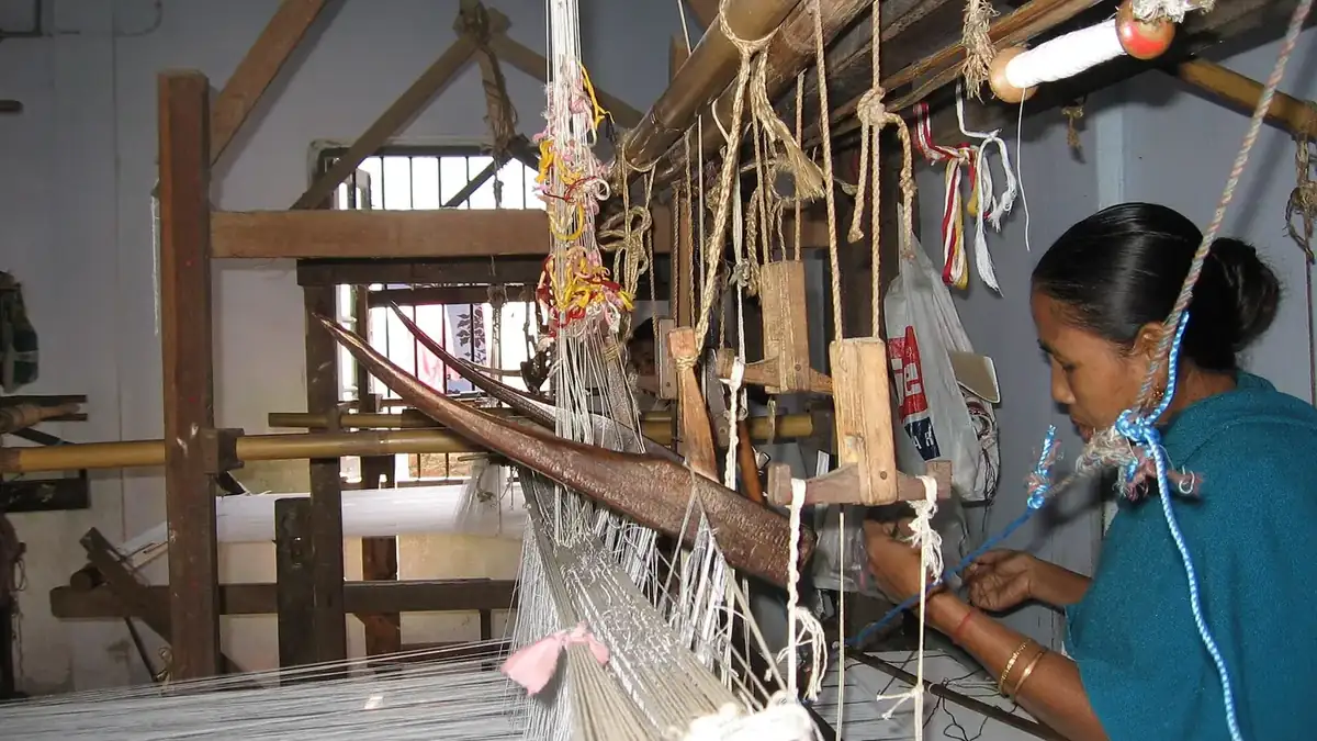 An Assamese woman weaving on a traditional handloom