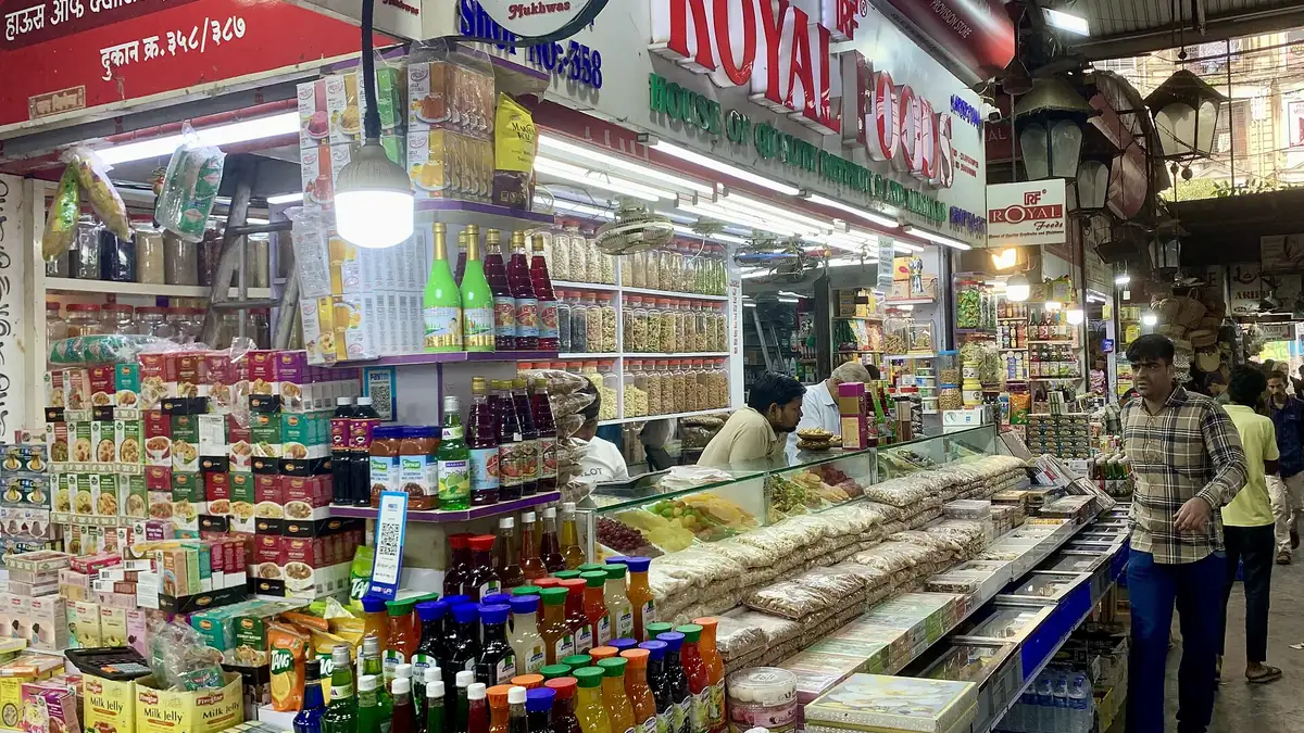 Shoppers and stalls selling provisions inside Crawford Market, Mumbai