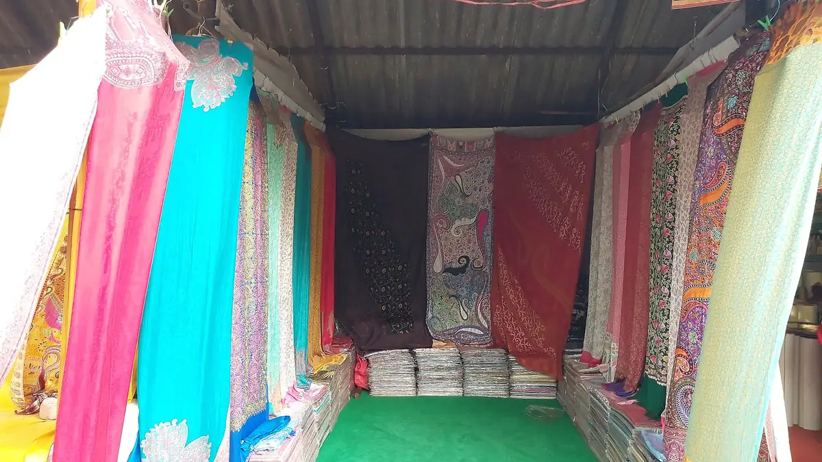 Colourful sarees hanging in a saree stall at Shilparamam