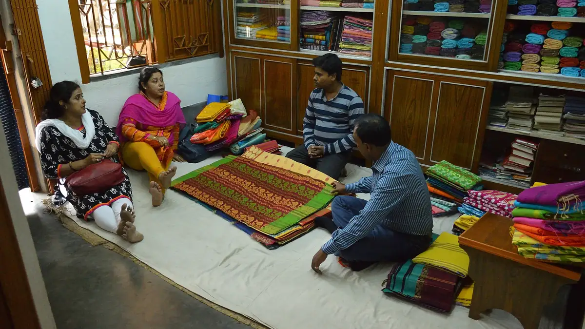 Customers choosing Tant sarees in a family-run shop in Nadia, West Bengal