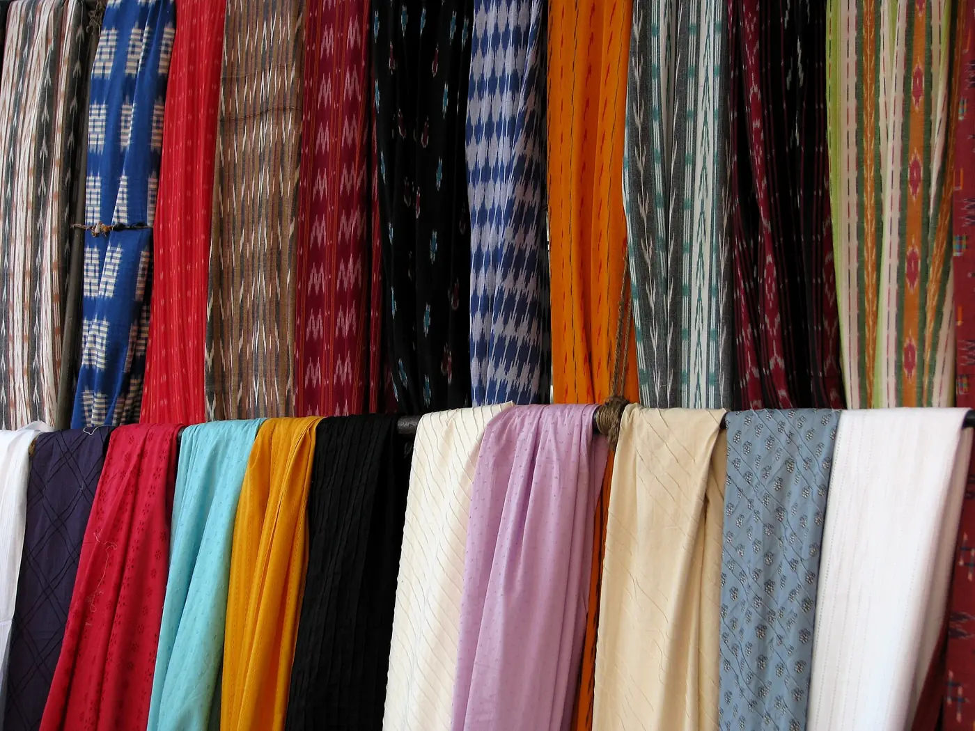 Rows of brightly coloured fabrics for sale at a Chennai market