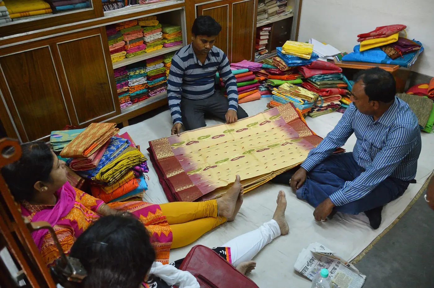 Shoppers choosing tussore sarees spread across a shop floor