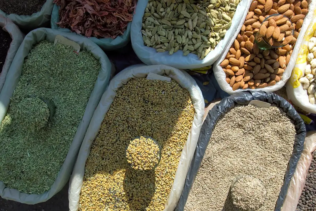 Sacks of lentils, cardamom, almonds and chillies at a spice market